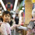 A little girl takes a robot's hand. Image courtesy of Andy Kelly on Unsplash