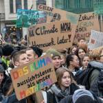 Young people demonstrating on a climate protest, photo by Mika Baumeister on Unsplash