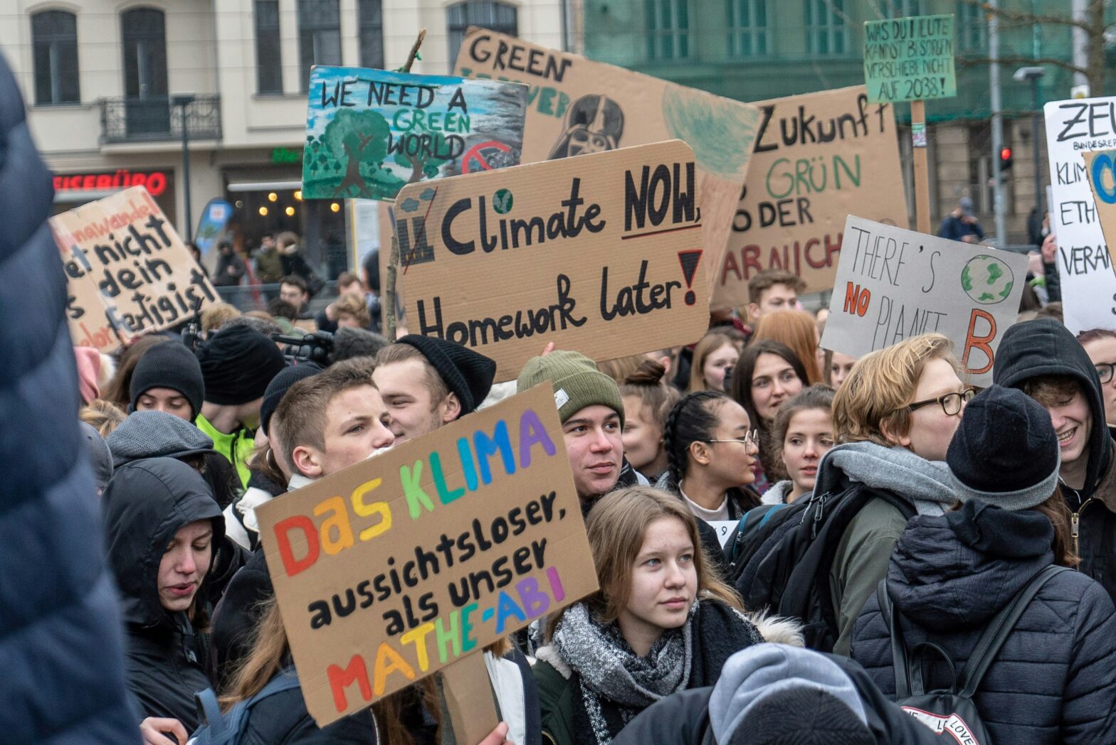 Young people demonstrating on a climate protest, photo by Mika Baumeister on Unsplash