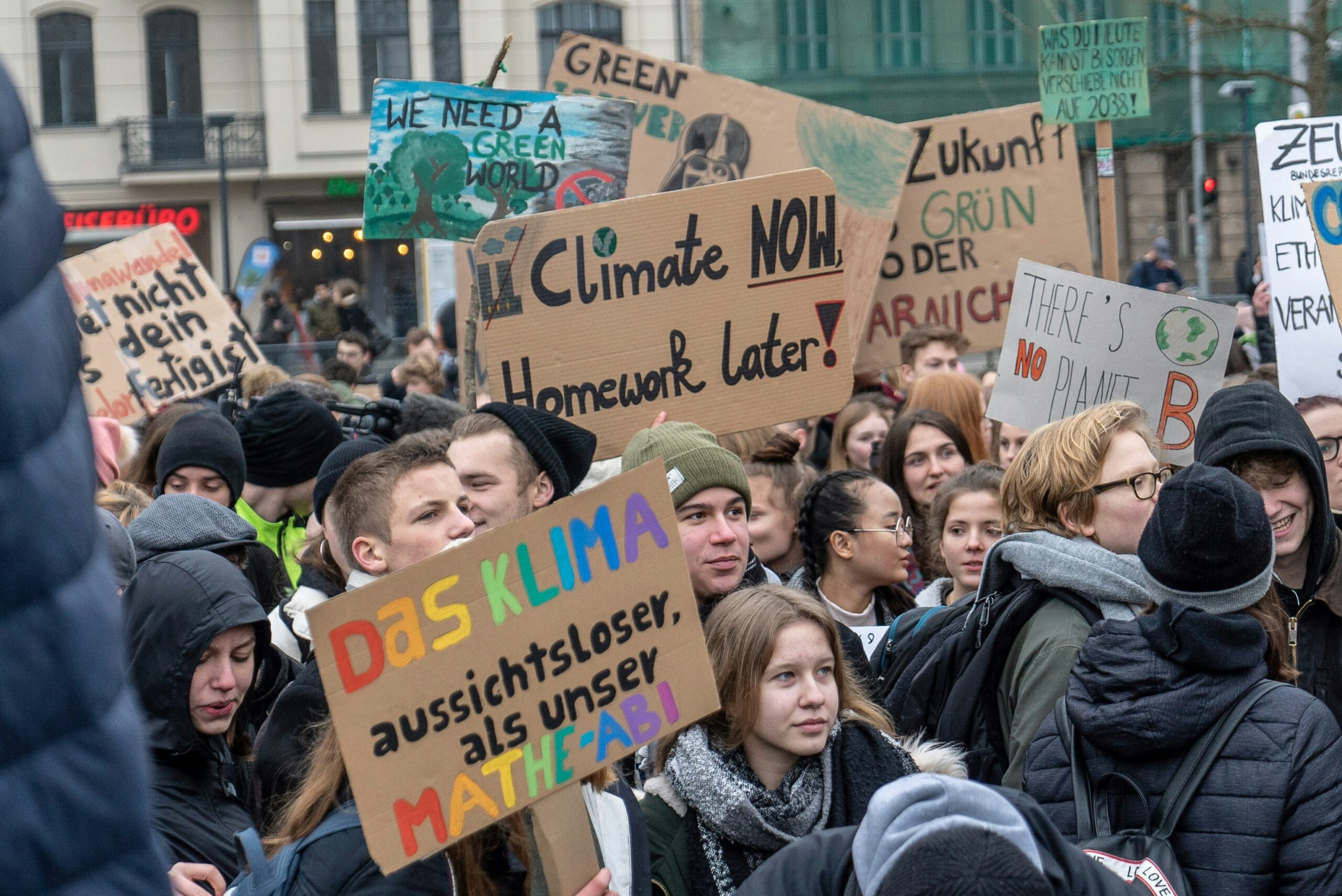 Young people demonstrating on a climate protest, photo by Mika Baumeister on Unsplash