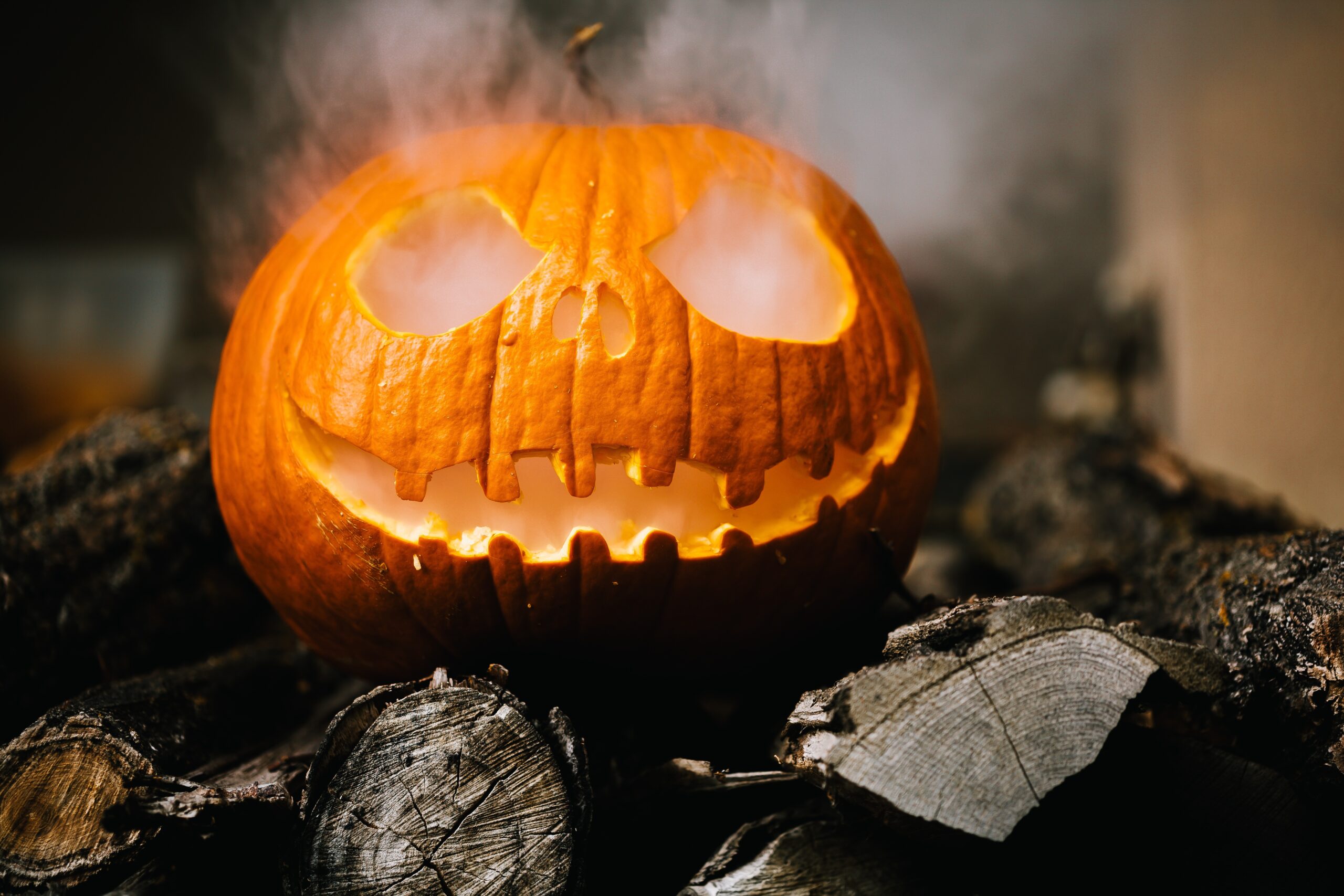 A Halloween pumpkin face with mist coming from its eyes