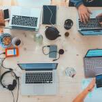 Original photo of gadgets on a table from unsplash https://unsplash.com/photos/people-sitting-down-near-table-with-assorted-laptop-computers-SYTO3xs06fU