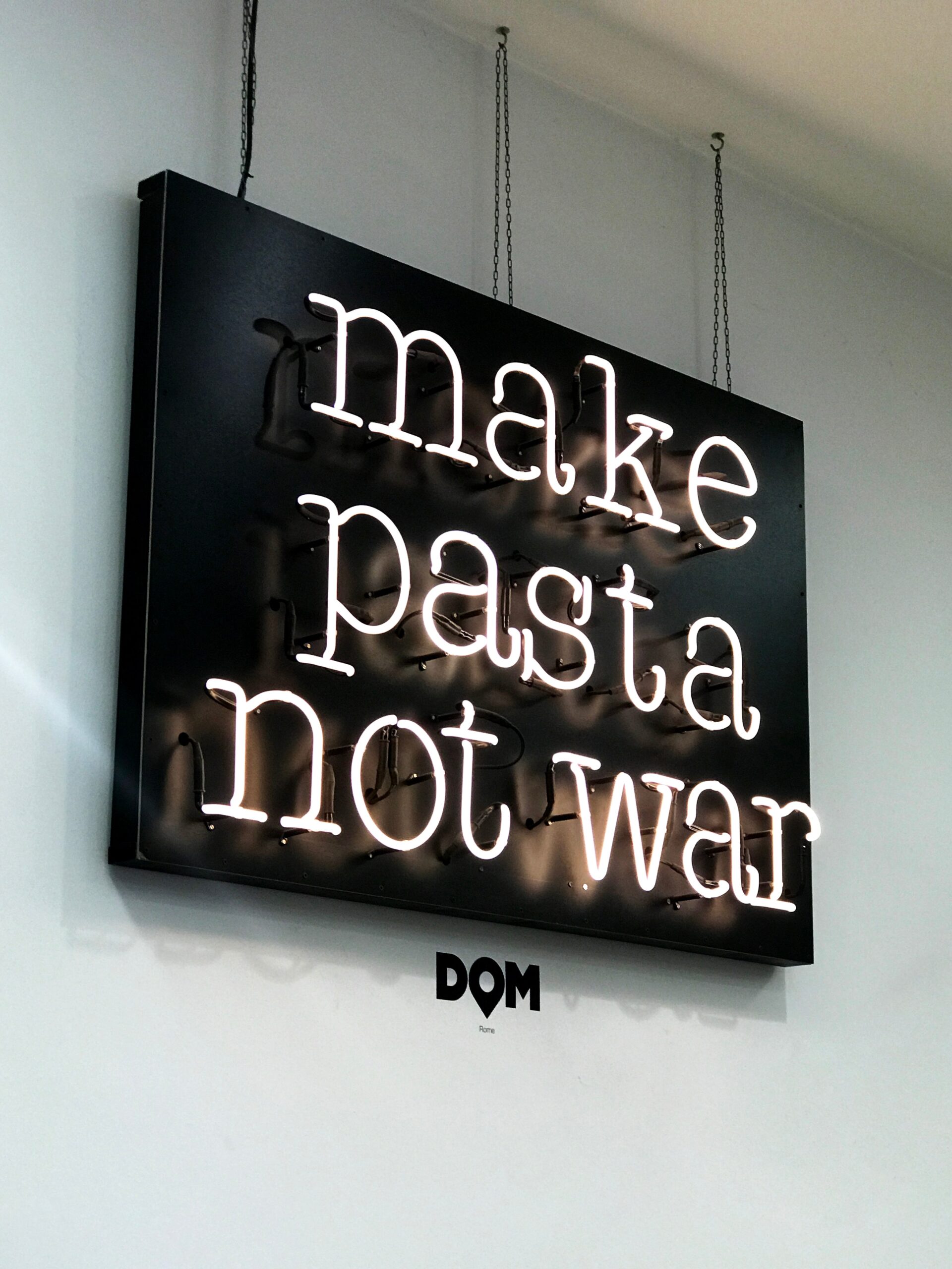 Photo of a neon light saying make pasta not war. Photo by Natasha Polyakova on Unsplash