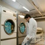 Man and tumble dryer. Photo by Tima Miroshnichenko